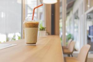 Iced coffee on a wooden table in the shop. photo