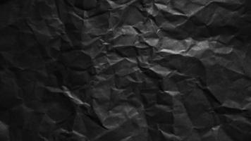 Textured crumpled black paper background. photo