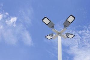 Solar light poles installed outside the building on a bright day sky background. photo