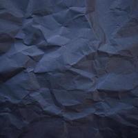 Textured crumpled black paper background. photo