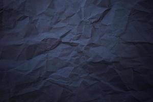 Textured crumpled black paper background. photo