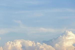 clear blue sky with plain white cloud with space for text background. The vast blue sky and clouds. blue sky background with tiny clouds nature. photo