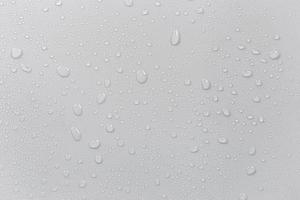 The concept of raindrops falling on a gray background Abstract wet white surface with bubbles on the surface Realistic pure water droplet water drops for creative banner design photo