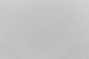The concept of raindrops falling on a gray background Abstract wet white surface with bubbles on the surface Realistic pure water droplet water drops for creative banner design photo