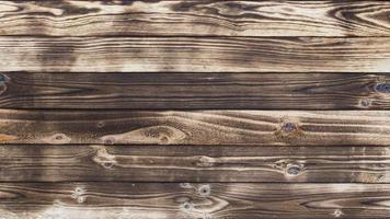 Wooden floor with traces of being burnt makes a black abstract background and texture. photo