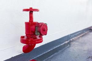 Red on-off valve on the transport ship. photo