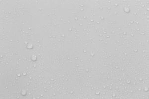 The concept of raindrops falling on a gray background Abstract wet white surface with bubbles on the surface Realistic pure water droplet water drops for creative banner design photo