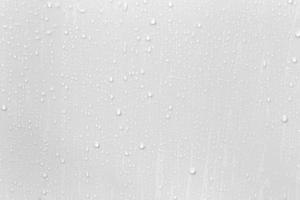 The concept of raindrops falling on a gray background Abstract wet white surface with bubbles on the surface Realistic pure water droplet water drops for creative banner design photo