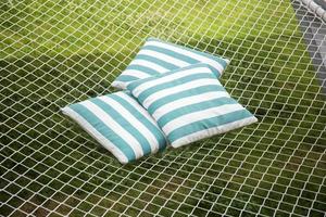 Comfortable top view pillows are placed on a rope net for rest and relaxation. photo