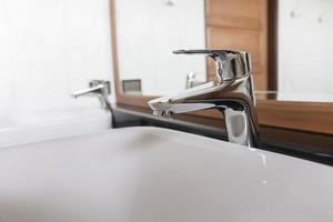 Stainless steel faucet, elegant sink. photo