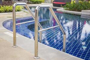 Ladder stainless handrails for descent into swimming pool. photo