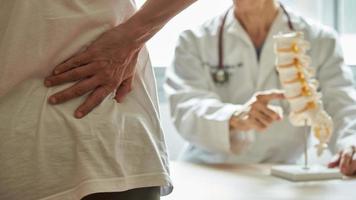 Back pain patient visiting doctor in clinic
