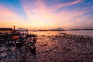 Beautiful sky in the morning during sunrise and fisherman long tail boats photo