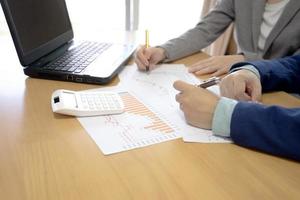 Hands of business people working with financial documents photo