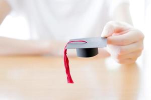 woman holding graduation cap photo