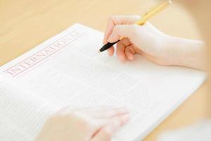 Woman writing on paper photo