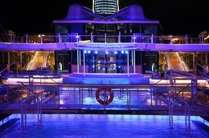 Miami, Florida, USA, Cruise ship swimming pool at night on the top deck with scenic views photo