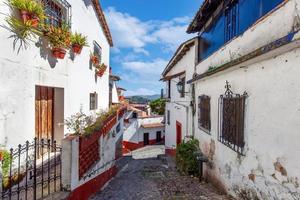 Mexico, Scenic Taxco colonial architecture and cobblestone narrow streets in historic city center near Santa Prisca church photo