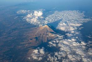 A scenic aerial view of Popocatepetl, a second highest peak in Mexico. It is an active stratovolcano, located in the states of Puebla, Morelos and Mexico, in central Mexico. photo