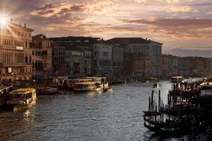 Venice Canals and gondolas near Rialto Bridge and Saint Marco square at sunset photo