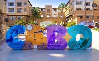 Los Cabos colorful letters in Cabo San Lucas marina a departure point for cruises, marlin fishing and lancha boats to El Arco Arch and beaches