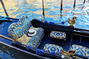 Luxury Gondola waiting for tourists near Rialto Bridge in Venice photo