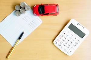 Coins stack in columns, saving book, car. Finance and banking concept. photo