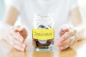 Woman holding money jar with coins close up photo