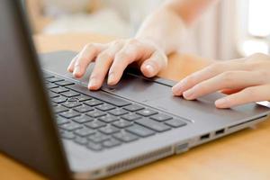 programmer's hand typing with laptop. focus on his finger photo