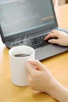 Businesswoman using tablet computer-net book and drinking coffee photo