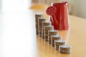 Red watering can with coin path in side isolate photo