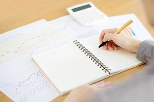 picture of woman hand with calculator and papers photo