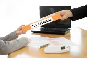 Businesswoman sends the investment document to the businessman. selective focus. photo