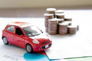 Car model and Financial statement with coins. finance and car loan concept photo