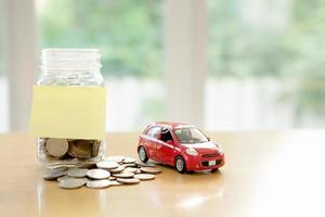 concepto de presupuesto educativo. ahorro de dinero del coche en un vaso foto