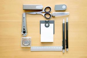 Open album with school supplies on the wooden table photo