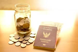 Savings jar with currency for travel photo