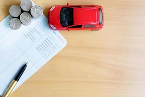 Coins stack in columns, saving book, car. Finance and banking concept. photo