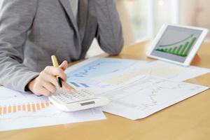 picture of woman hand with calculator and papers photo