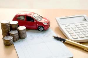 Coins stack in columns, saving book, car. Finance and banking concept. photo