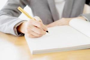 Woman writing on paper photo