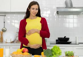 A pregnant woman in kitchen photo