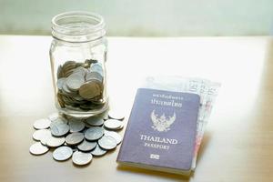 Savings jar with currency for travel photo