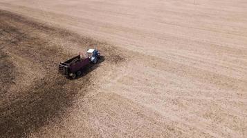 tractor on the field makes organic fertilizers aerial survey with a drone photo