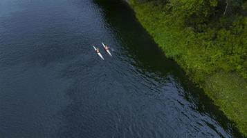 two swimmers floating down the river the view from the drone photo