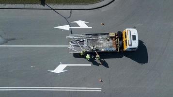 workers apply road markings top view photo