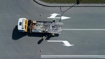 workers apply road markings top view photo