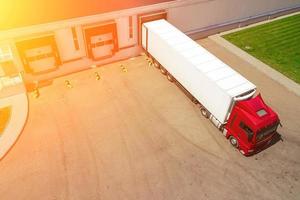 Aerial view of trucks unloading in logostics center photo