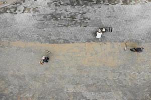 The masters lays paving stones. Sidewalk Repair. Road Workers Aerial View. photo