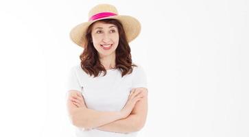 Happy beautiful middle age woman in summer hat isolated on white background. Summertime head and face skin care protection. Hot season and trendy women accessories. Template blank t shirt. Copy space. photo